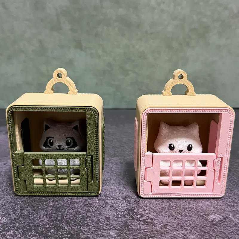 The Raccoon in the sage carrier and the Cat in the blush carrier, both peeking over the closed grate doors