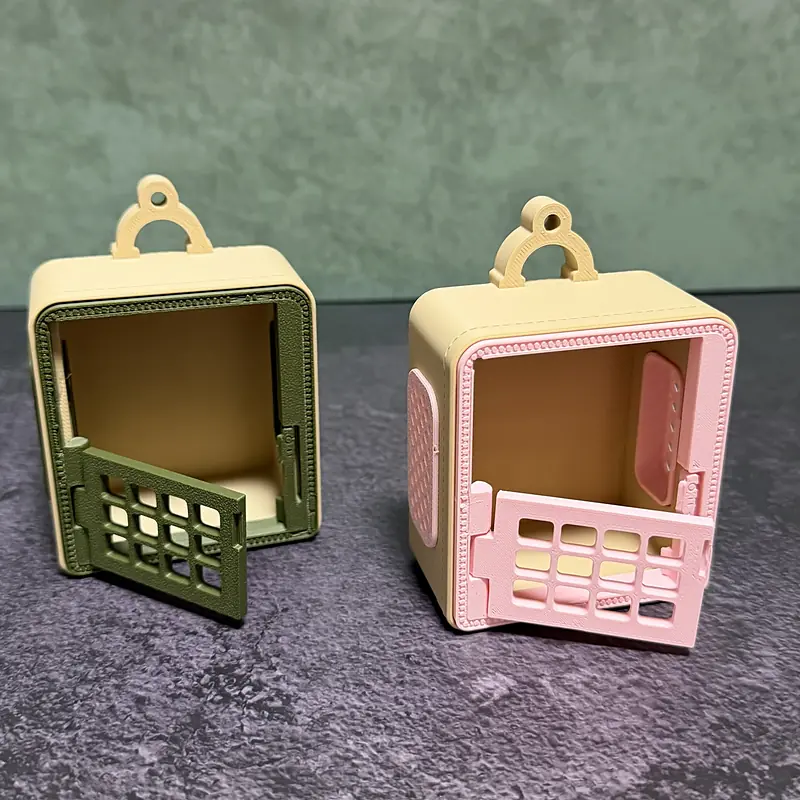 The sage and blush carriers standing empty with their grate doors open, showing the roomy cream interior